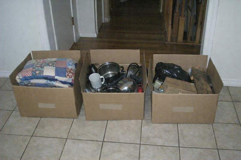 Three cardboard boxes on a tile floor labeled keep, donate and haul