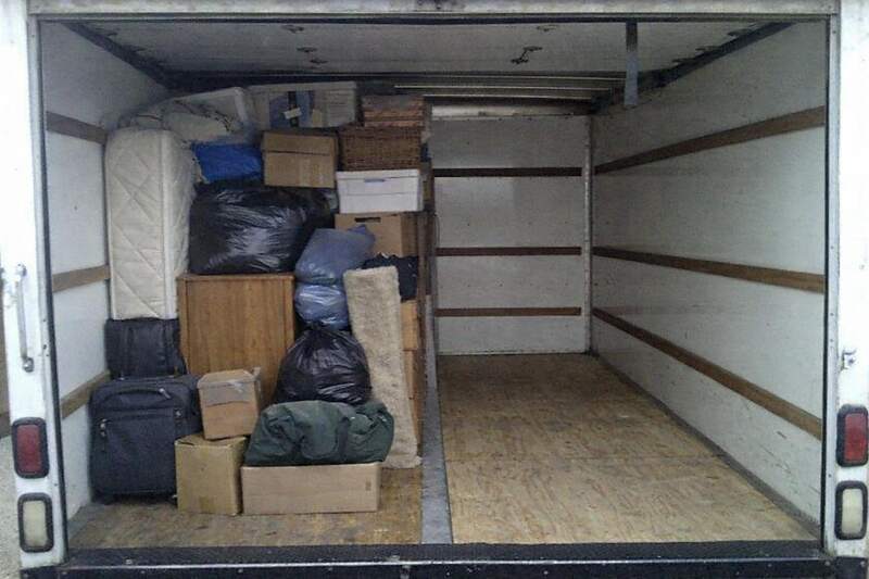 The open rear of a box truck showing the bed loaded to exactly the halfway line