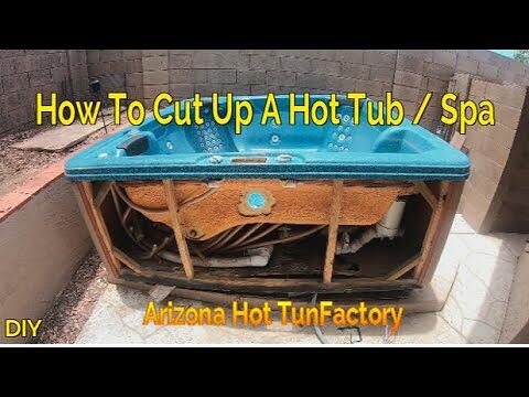 A hot tub shell being cut with a reciprocating saw