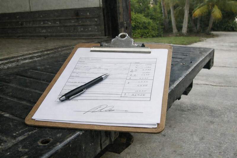 An estimate form on a clipboard on a truck tailgate, the document the price is agreed on